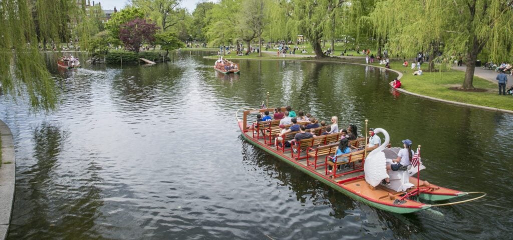 People rid on an iconic Swan Boat in the Boston Public Garden.