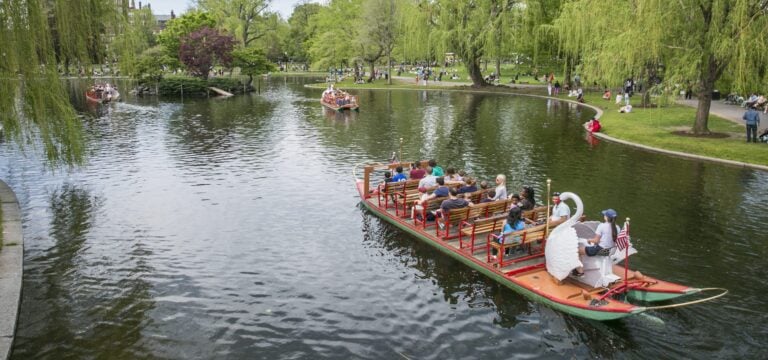People rid on an iconic Swan Boat in the Boston Public Garden.