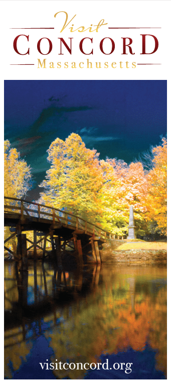 A wooden bridge crosses a calm river surrounded by colorful autumn trees with a tall monument in the background. Text reads: “Visit Concord Massachusetts” and “visitconcord.org” at the bottom, inviting you to experience the beauty of Concord.