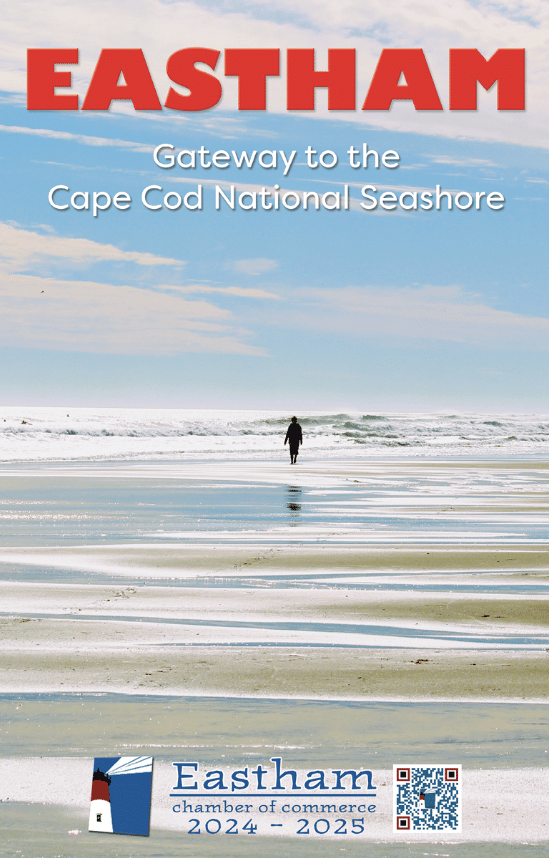 A person walks along a wide, reflective beach under a partly cloudy sky. Bold red text reads EASTHAM, with white text below: Gateway to the Cape Cod National Seashore. Eastham Chamber of Commerce logo is at the bottom.