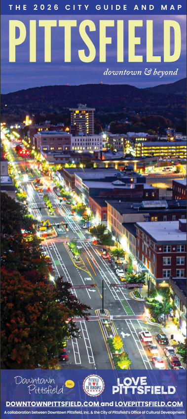 A vibrant, illuminated aerial view of downtown Pittsfield, Massachusetts at dusk, with cars and streetlights lining the main street. Text reads: “PITTSFIELD – The 2026 City Guide and Map – discover downtown & beyond.”.
