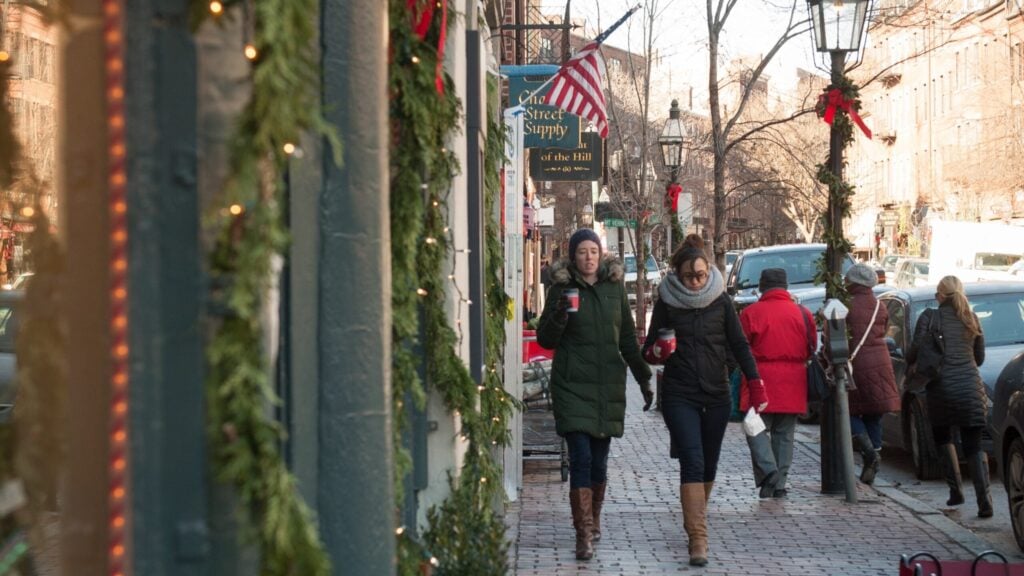 Shoppers walk down Newbury street in Boston.