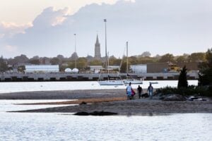 People walk along the New Bedford waterfront.