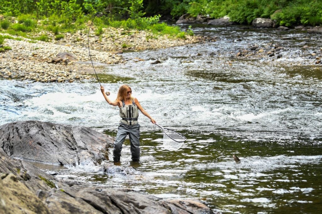 A person goes fly fishing.