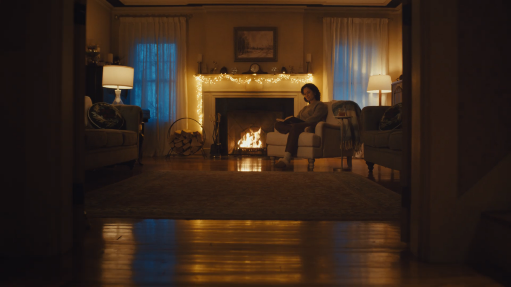 A person relaxes by the fire in a cozy inn.