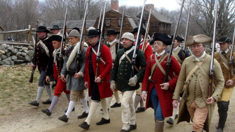 Revolutionary War reenactors march on Patriots' Day.