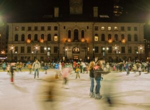 Skaters have fun on the Worcester Common Oval ice skating rink in Worcester, Massachusetts, at night.