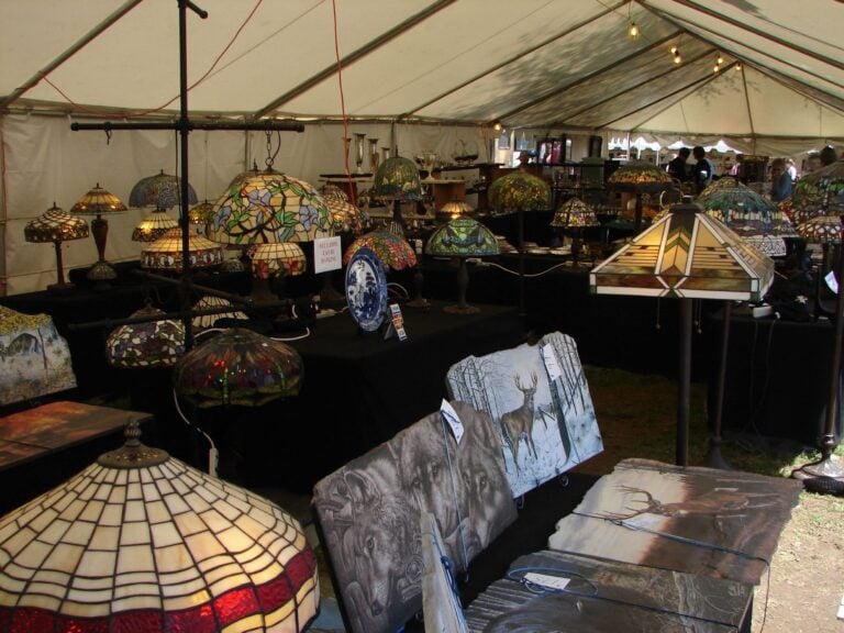 A variety of goods for sale at the Brimfield Fair, including furniture, lamps, and art.
