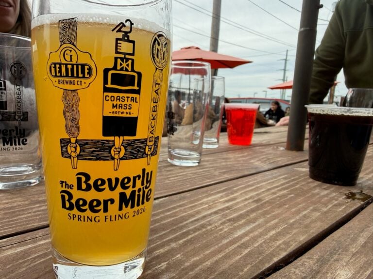 A glass of beer in a decorated glass that reads "The Beverly Beer Mile Spring Fling 2026"