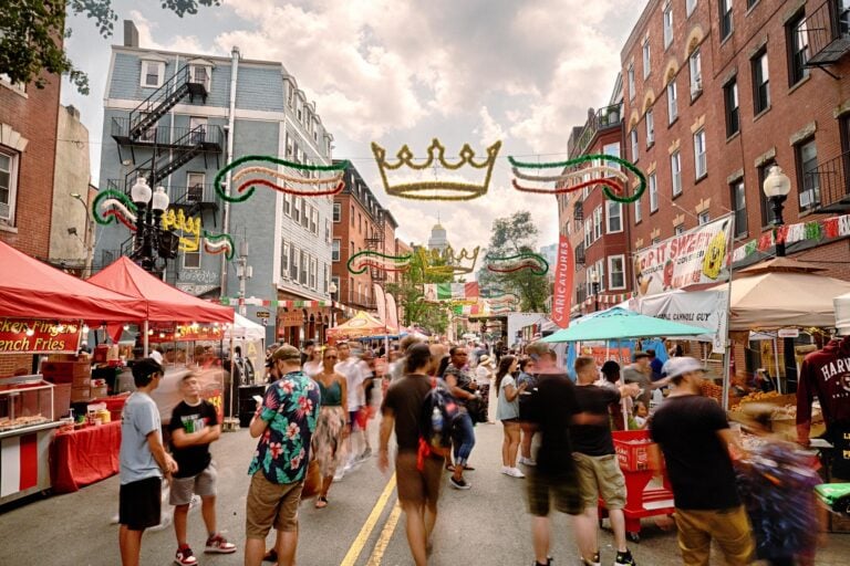 Revelers celebrate in the street under a green, white, and red banner at St. Anthony's Feast in Boston. Photo Credit: Kyle Klein Photography