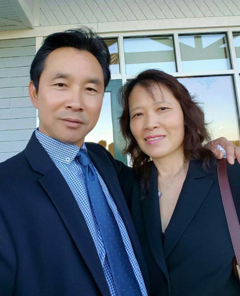 A couple, Eric and Julie Quan of Quan's Kitchen, poses together.