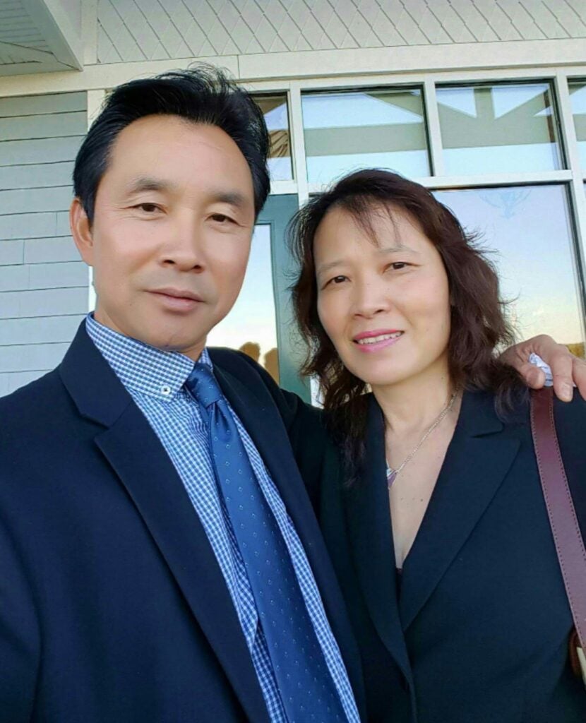 A couple, Eric and Julie Quan of Quan's Kitchen, poses together.