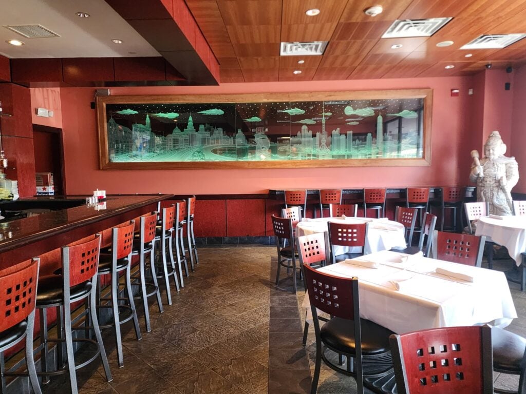 A restaurant interior with red walls and red furniture.