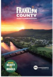 Aerial view of a river winding past a bridge and forested hills in Franklin County; text reads Franklin County and More Beauty to Behold.